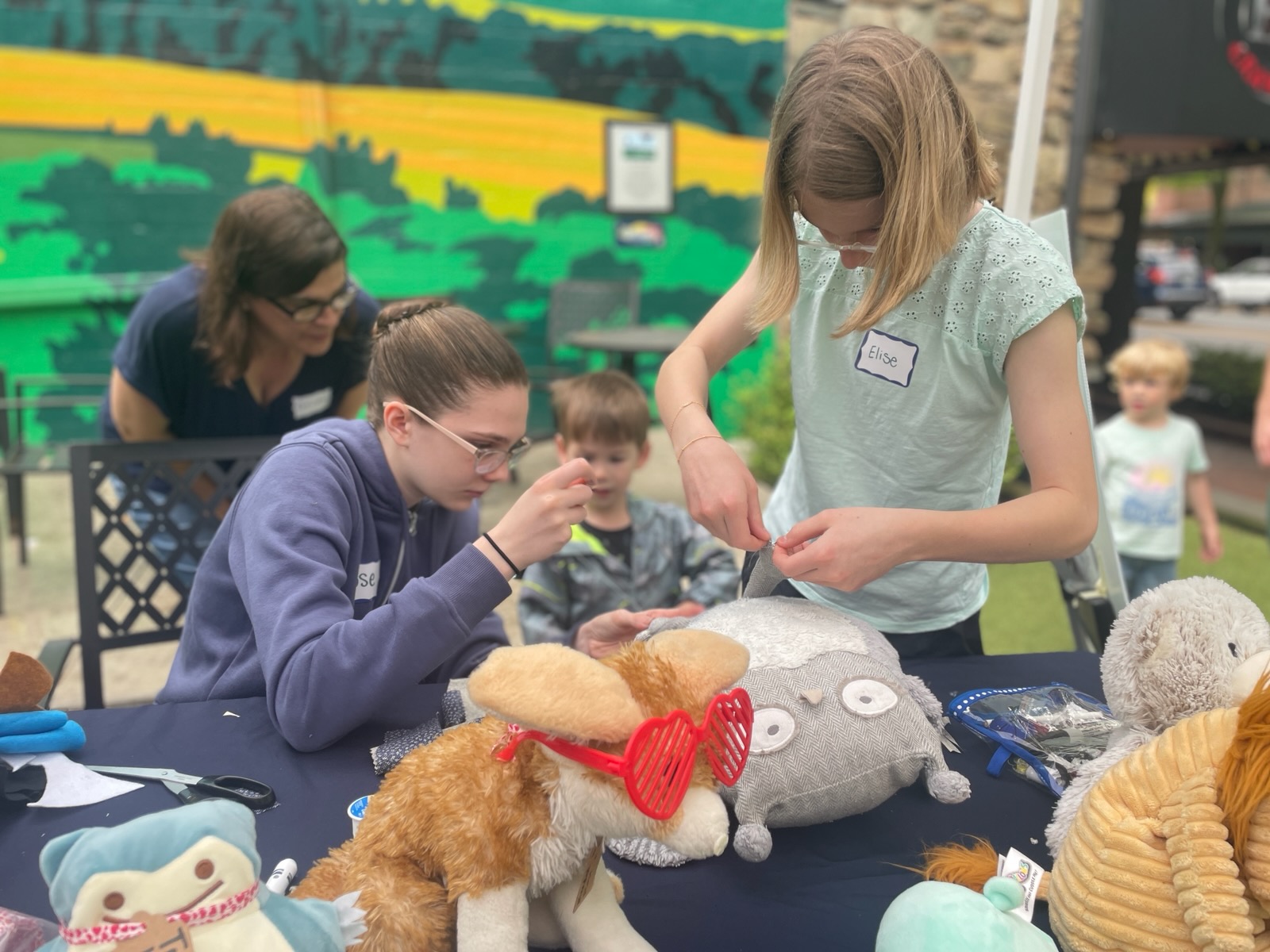 youth fixing teddy bears